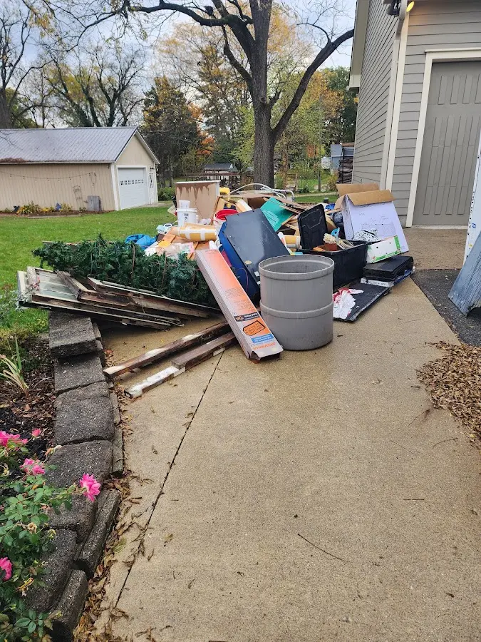 Dumpster being loaded with debris for Residential Dumpster Rental in Monmouth